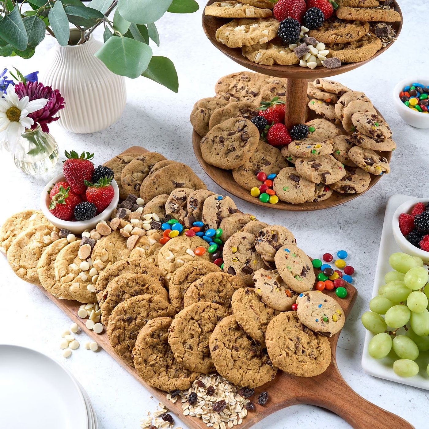 Tiered cookie display with fresh strawberries, blackberries, M&Ms, and grapes