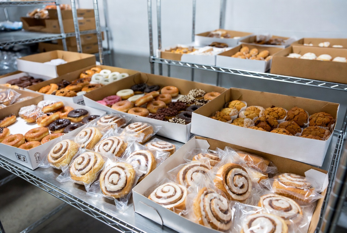 Overnight-ready pastry spread with donuts and wrapped cinnamon rolls